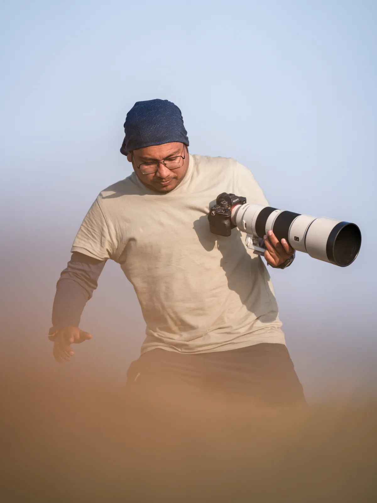 Abhisek in the field with a long telephoto lens, in dust and low light.